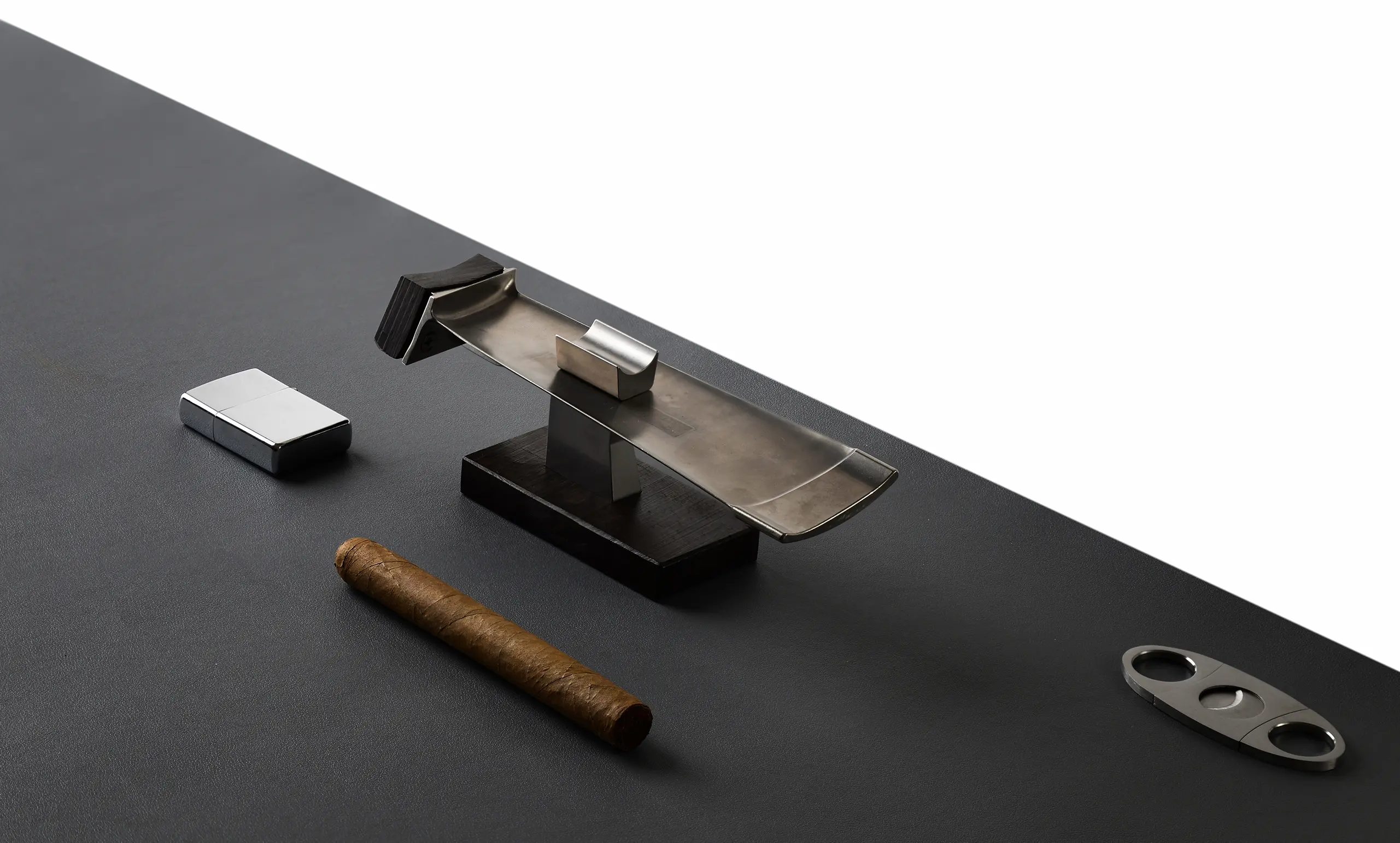 Aelyron limited-edition designer ashtray, precision-crafted from honest materials in an architectural dusk scene.